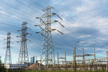 View of a power plant with many power lines on a background of beautiful cloudy sky