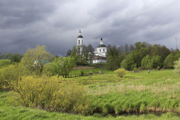 Fototapeta na wymiar Landscape with church in Russian village