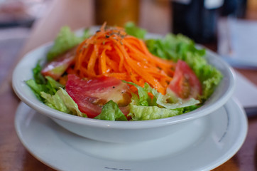 Salad with olive oil, carrot, tomato, lettuce