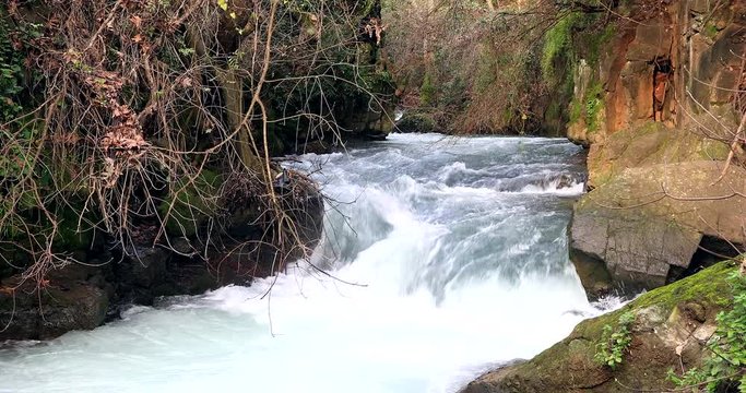 Fast-flowing rainwater into a river. (with sound).