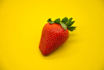 juicy strawberries on a yellow background