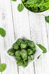 Frozen spinach cubes (close up; selective focus)