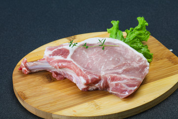 Raw pork bone steak over wooden