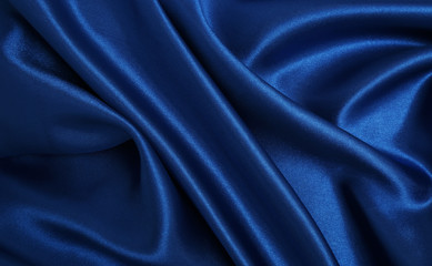 Smooth elegant blue silk or satin luxury cloth texture as abstract background. Luxurious Christmas background or New Year background design