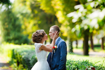 Happy bride and groom at their wedding. Newlyweds in the park.