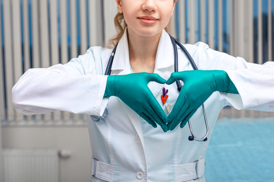 The doctor hands shows the heart, a symbol of health. Copy space, modern medicine, hypocrate oath