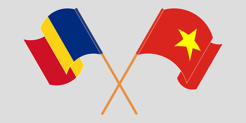 Crossed and waving flags of Romania and Vietnam