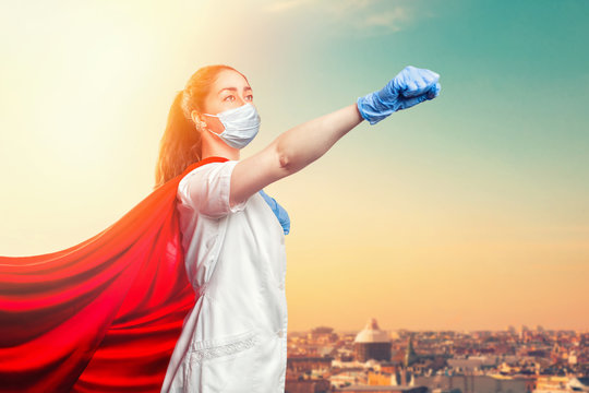 A doctor or nurse in a surgical face mask, gloves, and a superhero Cape. Medical personnel during a coronavirus outbreak. Super hero power for clinic and hospital personal. Copy space