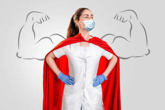 A doctor or nurse in a surgical face mask, gloves, and a superhero Cape. Medical personnel during a coronavirus outbreak. Drawn strong hands. Super hero power for clinic and hospital personal