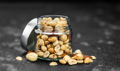 Roasted and salted nuts (close up; selective focus)