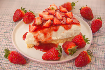 delicious cheesecake with strawberries on  plate