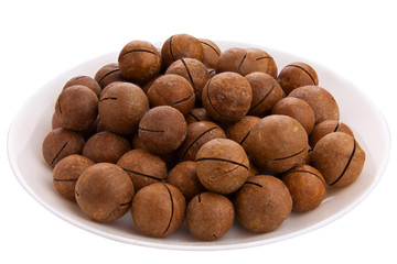 delicious macadamia nuts on  plate on  White background