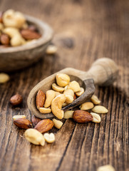 Roasted and salted nuts (close up; selective focus)
