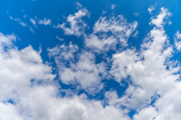 white clouds in the blue sky in sunny weather