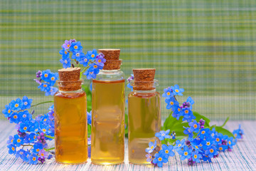 Essence of flowers on table in beautiful glass jar