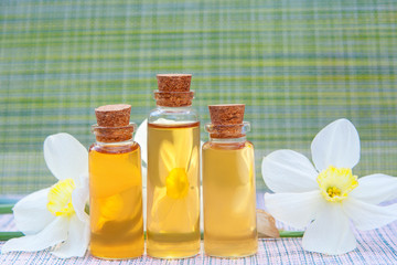 Essence of flowers  on white in beautiful glass jar