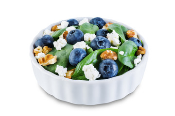 Spinach blueberry walnut Feta salad on a white isolated background