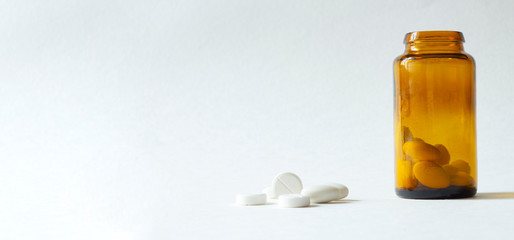 Pills from bottle on the white background