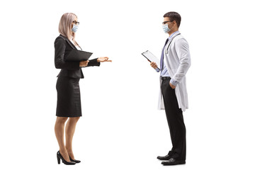 Businesswoman and a male doctor talking and wearing protective masks