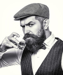 Man holding a glass of whisky. Portrait of man with thick beard. Degustation, tasting. Sipping whiskey. Macho drinking. Man with beard holds glass brandy. Bearded drink cognac. Black and white