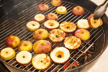  The process of making a dessert of apples on the grill. Fried apples. Barbecue fruit. Copy space Healthy, Vegan food
