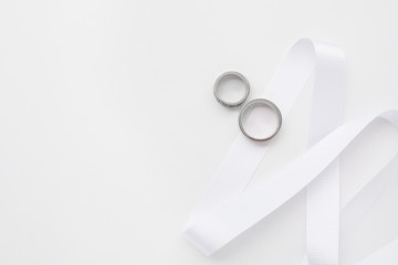 Wedding rings close-up on a white background top view. The concept of wedding cards.