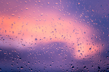 Raindrops On Glass Window During Sunset. Water drops on window by evening.