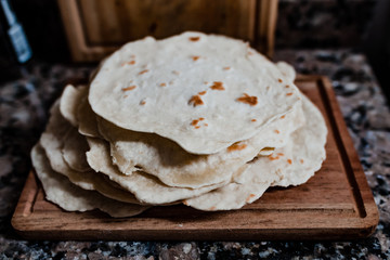 cooked Mexican taco tortillas placed on wooden board