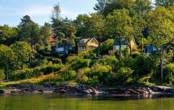 Panoramic view of Lindoya island on Oslofjord harbor near Oslo, Norway, with Lindoya Ost marina and summer cabin houses at shoreline in early autumn