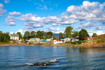 Fototapeta na wymiar Panoramic view of Lindoya island on Oslofjord harbor near Oslo, Norway, with Lindoya Ost marina and summer cabin houses at shoreline in early autumn
