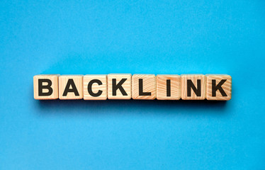 Back links - seo text with wooden cubes on a blue background