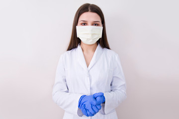 Female doctor wearing protection face mask and gloves.