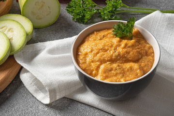 zucchini cream soup with parsley. Dietary and vegetarian dish on a white napkin

