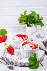 Strawberry ice cream in white bowl