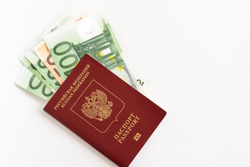 Russian passport with money for shopping abroad, travel and entertainment. Money is lying on the table light background.