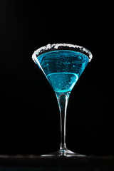 Cold alcohol cocktail with grenadine and lemon, blue lagoon