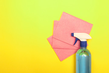 Cleaning, disinfection. Cleaning agent in a bottle with napkins on a yellow background. Means for...