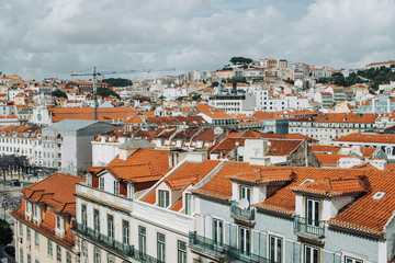 Fototapeta na wymiar View of the roofs and facades of typical buildings in Lisbon, tiled roofs in Europe. Architecture or travel destination concept