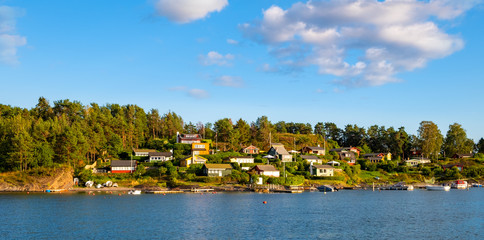 Panoramic view of Lindoya island on Oslofjord harbor near Oslo, Norway, with Lindoya Vest marina and summer cabin houses at shoreline in early autumn