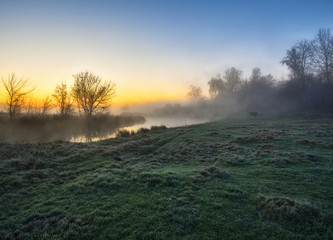autumn morning. foggy sunrise in a valley of a picturesque river