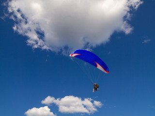 Fototapeta na wymiar Tandem paragliding in the blue skies