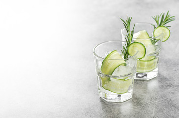 Fototapeta premium Cold summer beverage Fresh drink cucumber ice rosemary herb