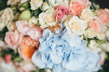 bridal bouquet on a bench. Wedding bouquet consisting of roses with rings
