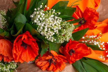 bouquet of orange poppies and lilies of the valley