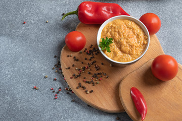 cream soup with paprika and tomatoes. Dietary and vegan dish on a wooden board top view

