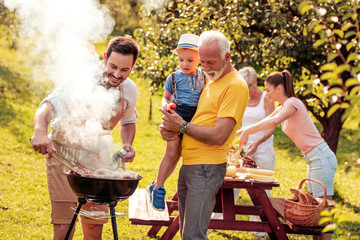 Family make barbecue together.