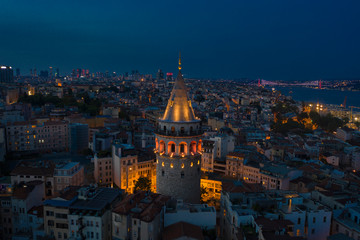 Fototapeta premium Galata Tower night aerial with Bosphorus Bridge on the background
