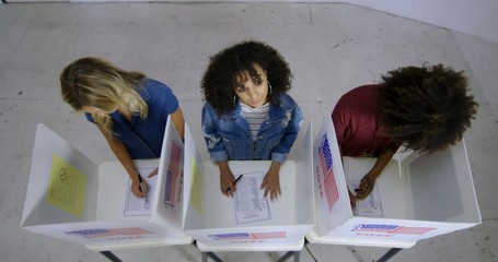 LS Wide overhead view three young women with Hispanic/Latina woman looking up and thinking while...