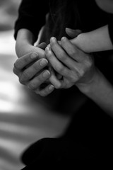 Close up cropped image loving tender mother gently touch hands of little daughter kid showing protection support expressing care and love. Mother's love in the hand, on the palm..