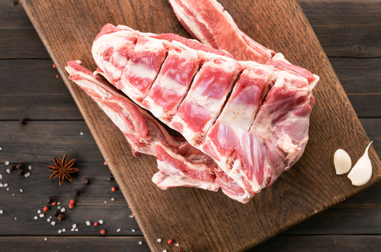 Raw meat, lamb saddle on a wooden background